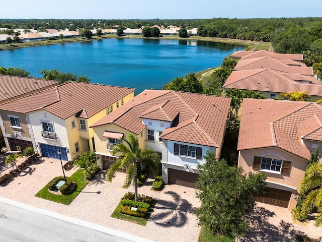 aerial view of residential area featuring a large body of water