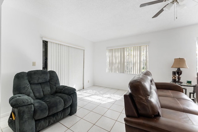 6292 Silver Moon Ln, Greenacres, FL 33463 - living room with baseboards, a textured ceiling, ceiling fan, and light tile patterned flooring