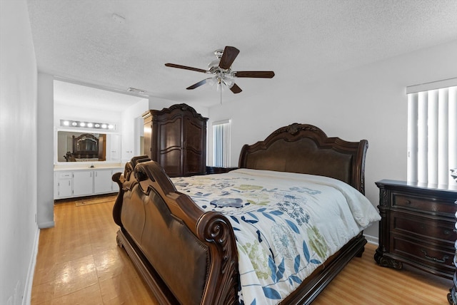6292 Silver Moon Ln, Greenacres, FL 33463 - bedroom with ceiling fan, ensuite bath, a textured ceiling, and visible vents