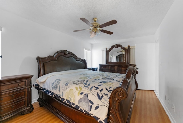 6292 Silver Moon Ln, Greenacres, FL 33463 - bedroom featuring baseboards, ceiling fan, light wood finished floors, and a textured ceiling
