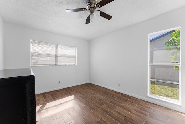 6292 Silver Moon Ln, Greenacres, FL 33463 - empty room with baseboards, a textured ceiling, ceiling fan, and wood finished floors