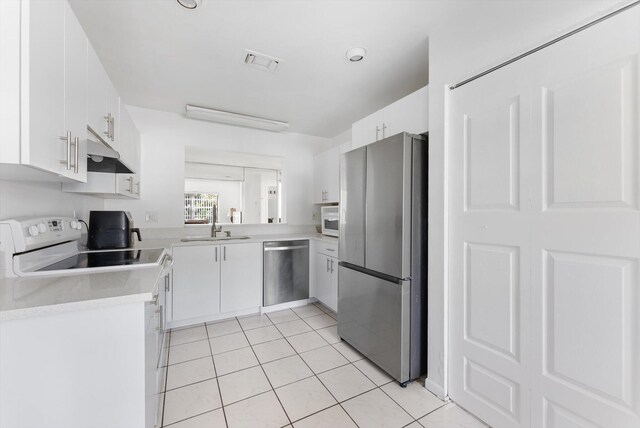 6292 Silver Moon Ln, Greenacres, FL 33463 - kitchen with light countertops, stainless steel appliances, light tile patterned floors, under cabinet range hood, and visible vents
