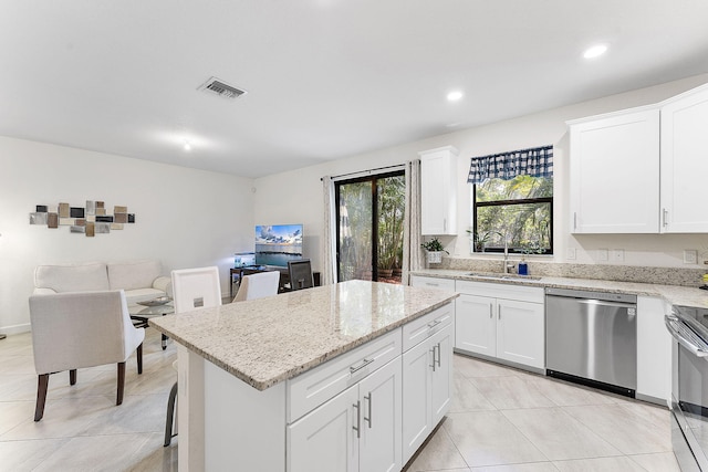 12968 Anthorne Ln, Boynton Beach, FL 33436 - kitchen featuring a sink, stainless steel appliances, light tile patterned floors, a kitchen island, and visible vents