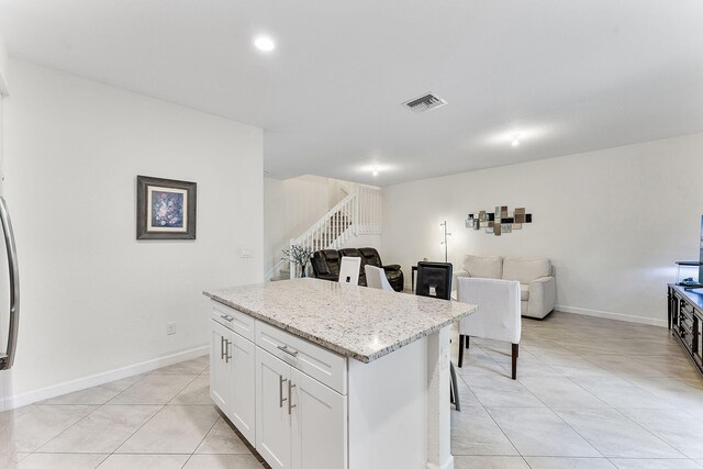 12968 Anthorne Ln, Boynton Beach, FL 33436 - kitchen with light tile patterned floors, a center island, white cabinets, and visible vents