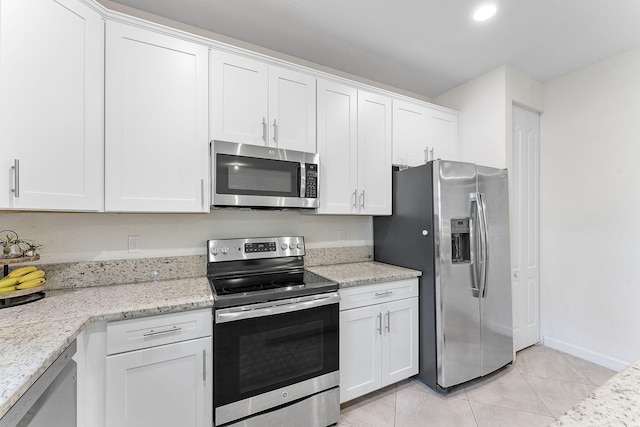 12968 Anthorne Ln, Boynton Beach, FL 33436 - kitchen with white cabinets, stainless steel appliances, light stone countertops, and light tile patterned floors