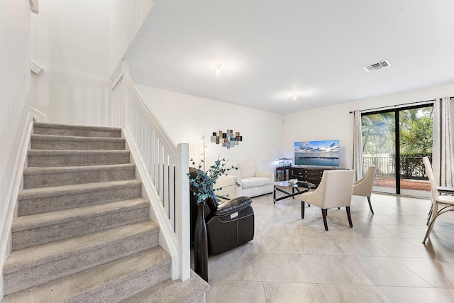 12968 Anthorne Ln, Boynton Beach, FL 33436 - living room featuring visible vents, light tile patterned floors, and stairway