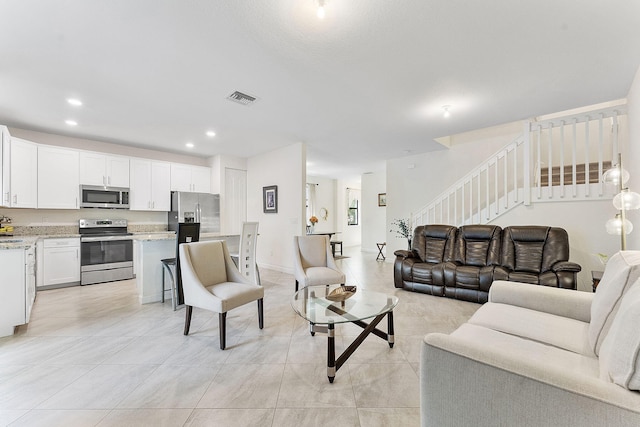 12968 Anthorne Ln, Boynton Beach, FL 33436 - living room with recessed lighting, visible vents, light tile patterned floors, and stairway