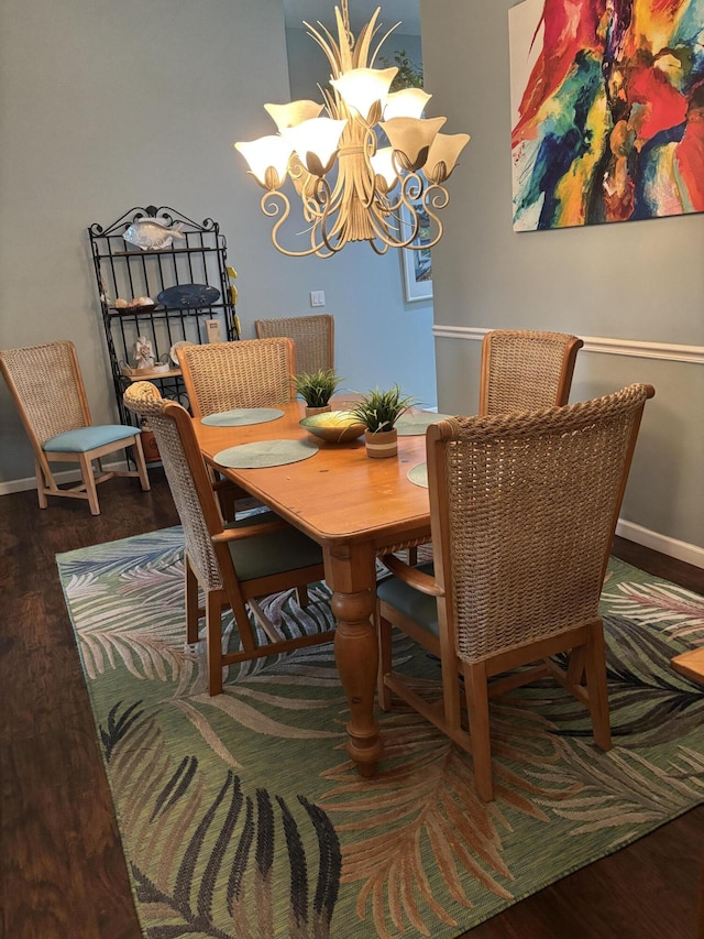 3237 El Camino Real, West Palm Beach, FL 33409 - dining area featuring baseboards, an inviting chandelier, and wood finished floors