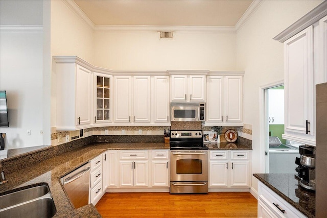 761 SW Lighthouse Dr, Palm City, FL 34990 - dining space with baseboards, ornamental molding, a sunroom, and hardwood / wood-style floors