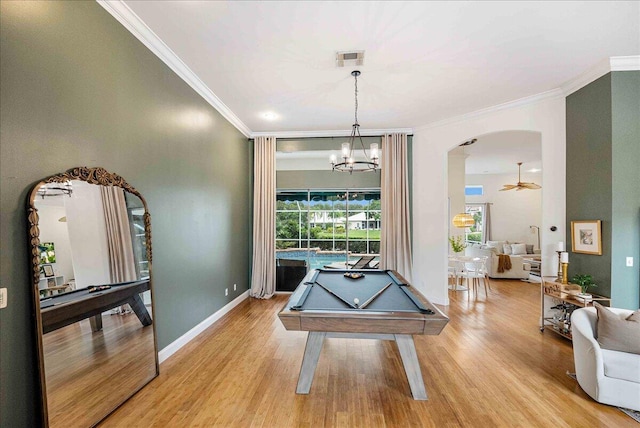 761 SW Lighthouse Dr, Palm City, FL 34990 - living area featuring crown molding, a decorative wall, wood finished floors, and a notable chandelier