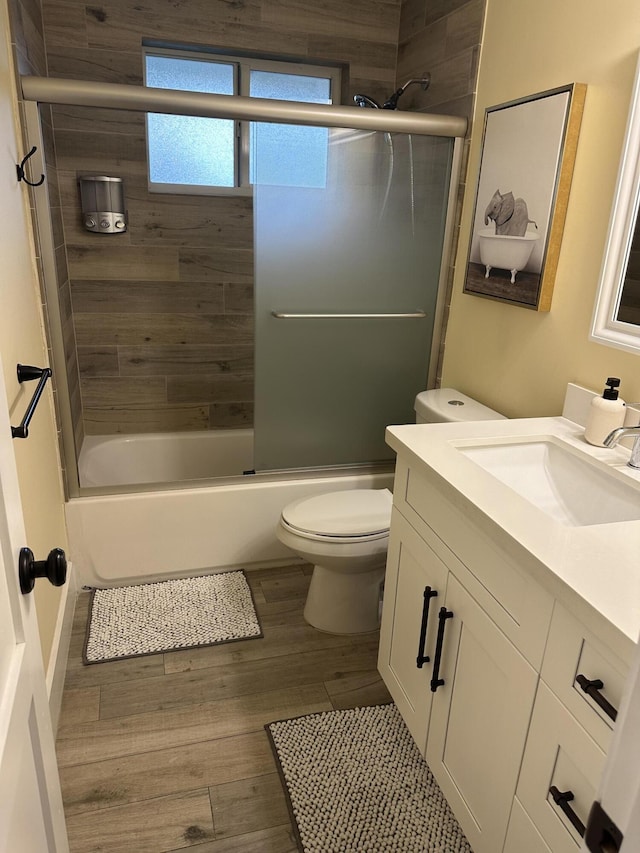 5111 NE 27th Ter NE, Lighthouse Point, FL 33064 - bathroom with vanity, wood finished floors, toilet, and enclosed tub / shower combo