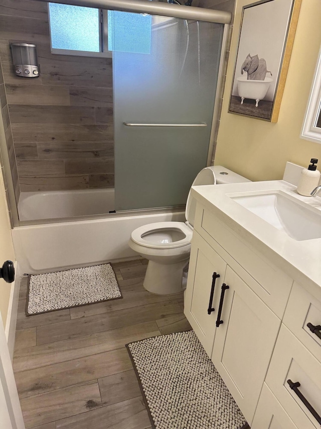 5111 NE 27th Ter NE, Lighthouse Point, FL 33064 - bathroom featuring vanity, toilet, wood finished floors, and shower / washtub combination