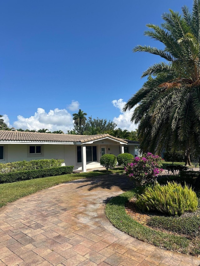 5111 NE 27th Ter NE, Lighthouse Point, FL 33064 - ranch-style home with a tiled roof, stucco siding, and curved driveway