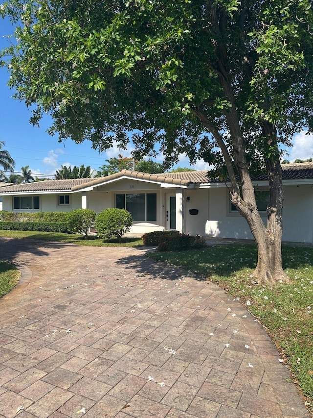 5111 NE 27th Ter NE, Lighthouse Point, FL 33064 - ranch-style house with a tiled roof, stucco siding, and decorative driveway