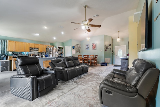 living area with ceiling fan, visible vents, and lofted ceiling