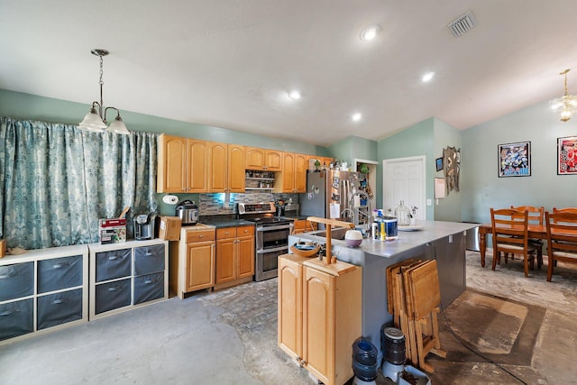 kitchen with visible vents, a center island with sink, appliances with stainless steel finishes, vaulted ceiling, and hanging light fixtures