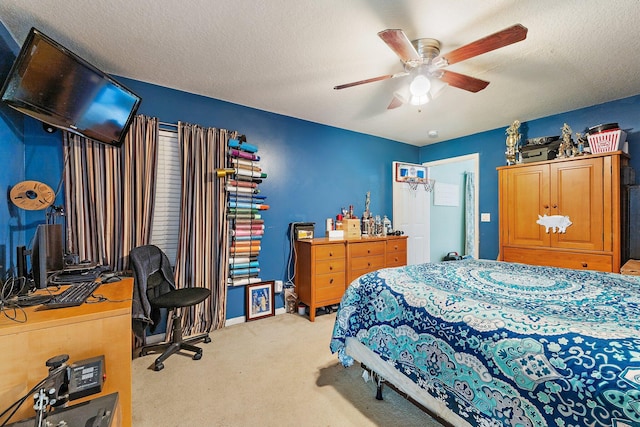 bedroom featuring a textured ceiling, ceiling fan, and light colored carpet