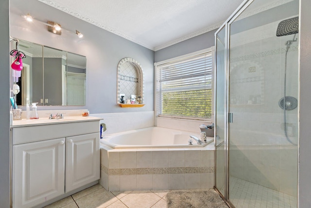 full bath with a garden tub, a stall shower, tile patterned floors, and vanity