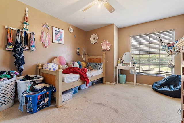 carpeted bedroom featuring a ceiling fan and baseboards