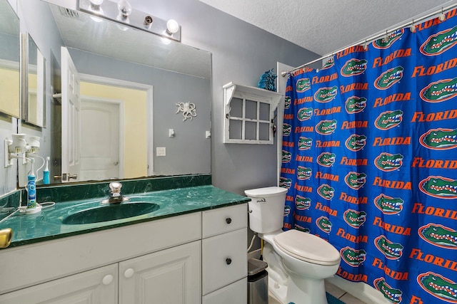 bathroom with vanity, toilet, a textured ceiling, and a shower with shower curtain