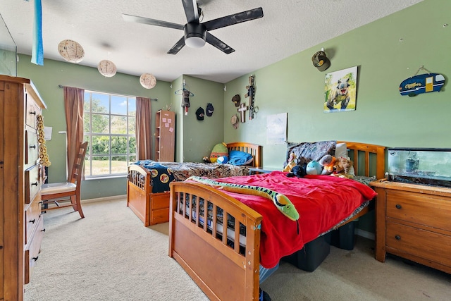 carpeted bedroom with a textured ceiling and ceiling fan