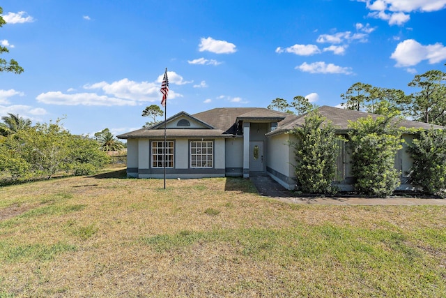 view of front of property with a front lawn and stucco siding