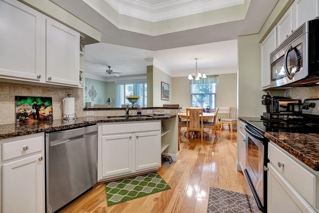 kitchen with open shelves, ornamental molding, light wood-type flooring, white cabinetry, and stainless steel appliances