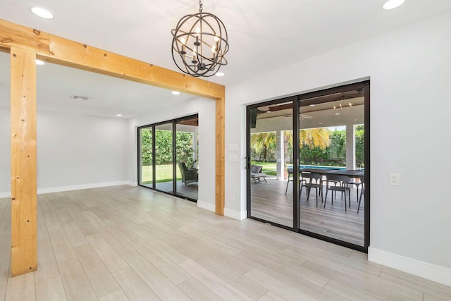 interior space with a chandelier, baseboards, and recessed lighting