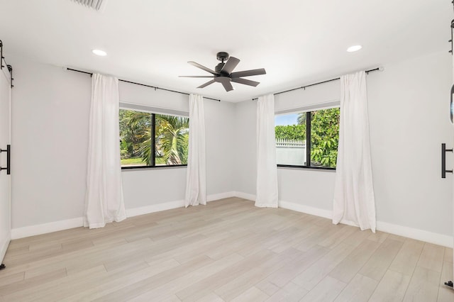 spare room with baseboards, a healthy amount of sunlight, and ceiling fan