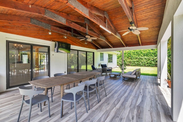 wooden deck with an outdoor hangout area and ceiling fan