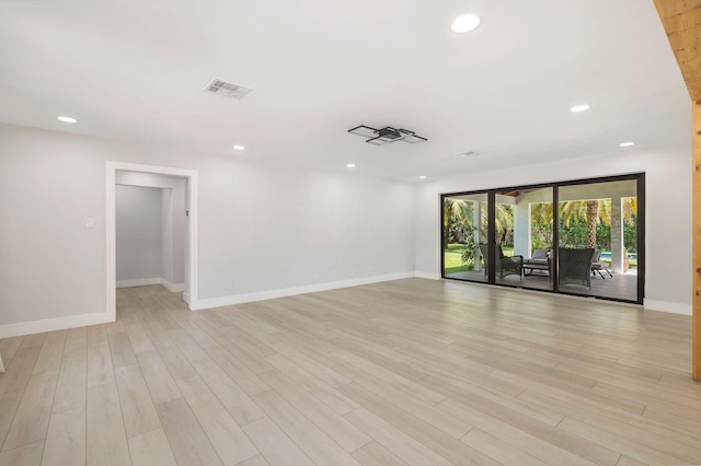 spare room with baseboards, recessed lighting, and visible vents