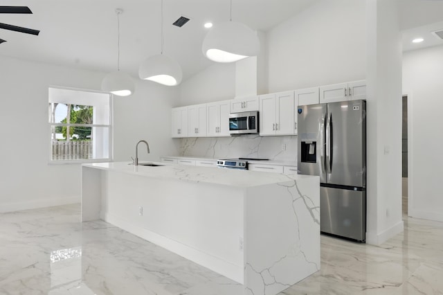 5104 Birch Dr, Fort Pierce, FL 34982 - kitchen with appliances with stainless steel finishes, a sink, tasteful backsplash, baseboards, and white cabinets