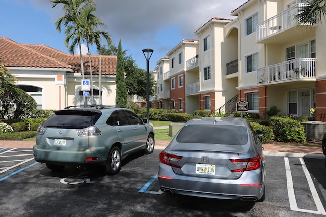 9825 Baywinds Dr Unit 1208, West Palm Beach, FL 33411 - uncovered parking lot with a residential view