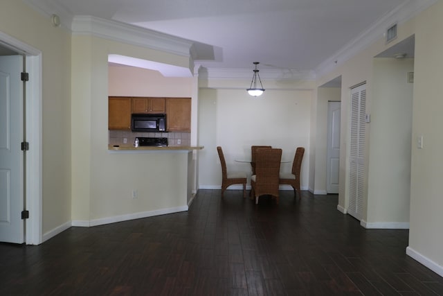 9825 Baywinds Dr Unit 1208, West Palm Beach, FL 33411 - kitchen featuring black microwave, brown cabinetry, dark wood-style flooring, ornamental molding, and decorative backsplash