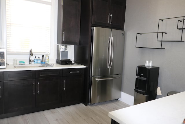9825 Baywinds Dr Unit 1208, West Palm Beach, FL 33411 - kitchen with freestanding refrigerator, a sink, light countertops, and light wood-style flooring