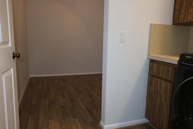 9825 Baywinds Dr Unit 1208, West Palm Beach, FL 33411 - laundry area with washer / dryer, dark wood-style flooring, baseboards, and cabinet space