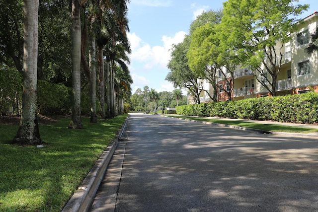 9825 Baywinds Dr Unit 1208, West Palm Beach, FL 33411 - view of asphalt road with curbs and sidewalks