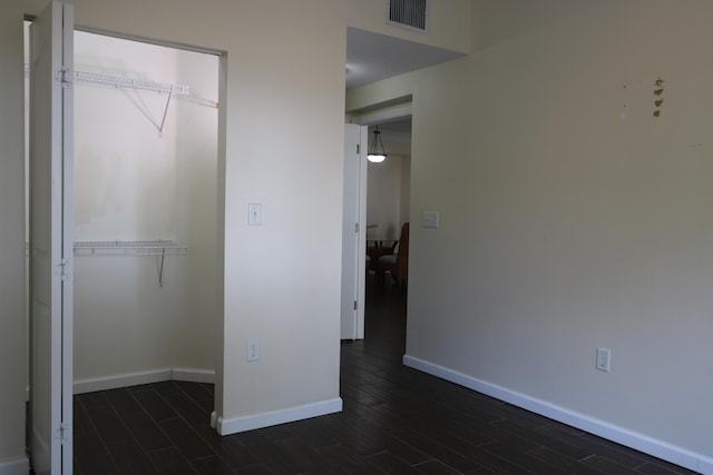 9825 Baywinds Dr Unit 1208, West Palm Beach, FL 33411 - unfurnished bedroom featuring baseboards, wood tiled floors, and a closet