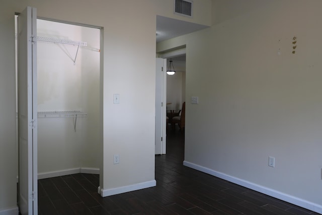 9825 Baywinds Dr Unit 1208, West Palm Beach, FL 33411 - unfurnished bedroom featuring wood tiled floors, baseboards, and a closet