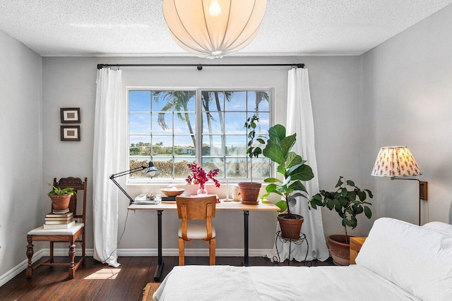 5031 Wiles Rd Unit 104, Coconut Creek, FL 33073 - dining area featuring baseboards, a textured ceiling, and wood finished floors