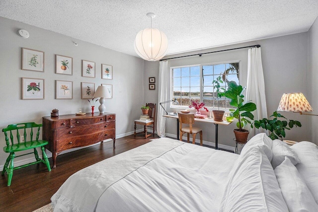 5031 Wiles Rd Unit 104, Coconut Creek, FL 33073 - bedroom with baseboards, a textured ceiling, and wood finished floors