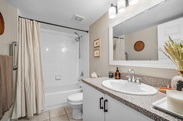 5031 Wiles Rd Unit 104, Coconut Creek, FL 33073 - bathroom with double vanity, visible vents, tile patterned flooring, a sink, and toilet