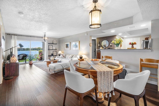5031 Wiles Rd Unit 104, Coconut Creek, FL 33073 - dining area featuring a textured ceiling and wood finished floors