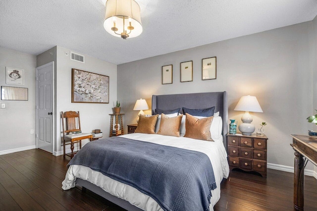 5031 Wiles Rd Unit 104, Coconut Creek, FL 33073 - bedroom with a textured ceiling, baseboards, visible vents, and hardwood / wood-style flooring