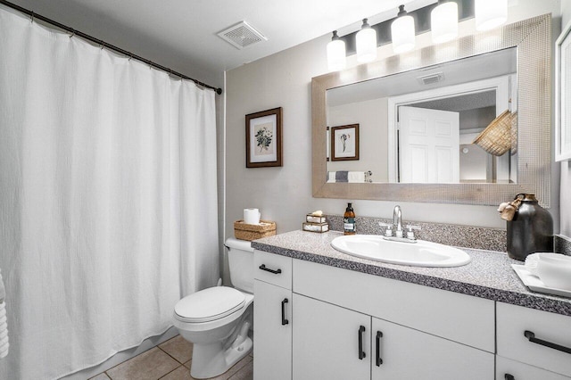 5031 Wiles Rd Unit 104, Coconut Creek, FL 33073 - bathroom with visible vents, tile patterned flooring, toilet, and vanity