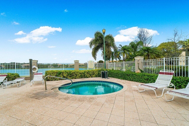 5031 Wiles Rd Unit 104, Coconut Creek, FL 33073 - view of swimming pool featuring fence, a patio, and a hot tub