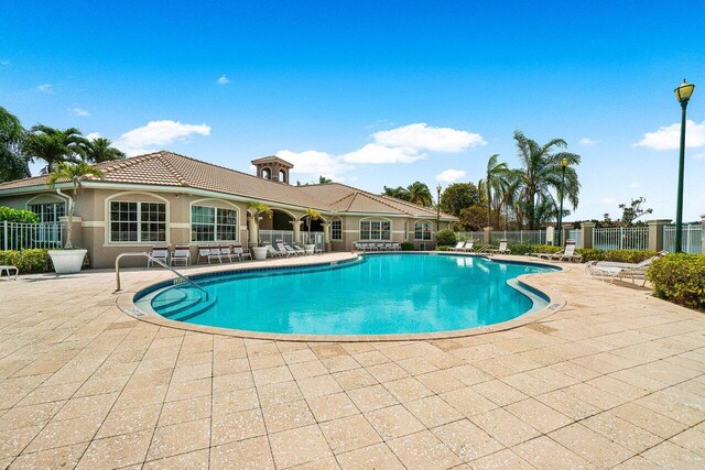 5031 Wiles Rd Unit 104, Coconut Creek, FL 33073 - community pool with a patio and fence