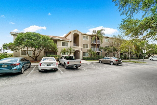 5031 Wiles Rd Unit 104, Coconut Creek, FL 33073 - view of building exterior with uncovered parking