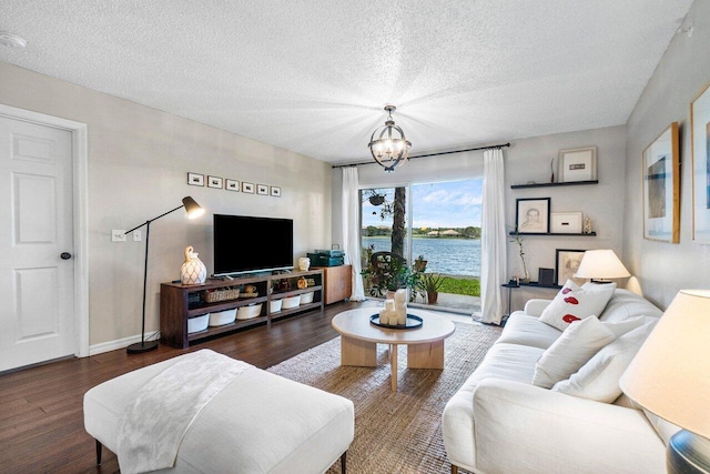 5031 Wiles Rd Unit 104, Coconut Creek, FL 33073 - living area featuring a textured ceiling, wood finished floors, and a notable chandelier