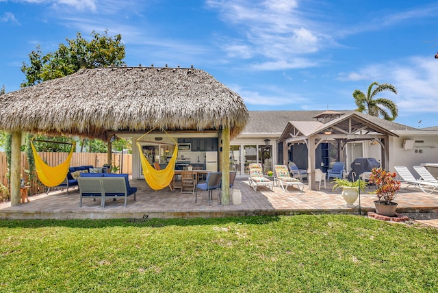 exterior space with a lawn, a gazebo, and fence